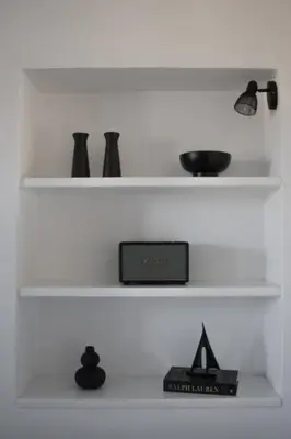a shelf with vases and a box on it at Duchess Harbour View in Symi