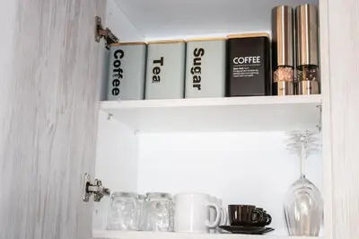 a shelf with books and glasses on it at Duchess Harbour View in Symi