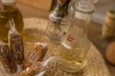 a table with a bottle of oil and some snacks at Filoxenia house in Kremasti