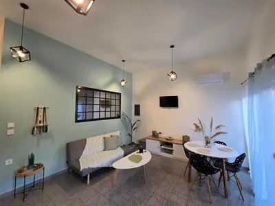 a living room with a couch and a table at Filoxenia house in Kremasti