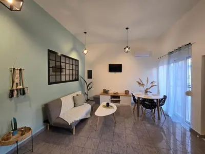 a living room with a couch and a table at Filoxenia house in Kremasti