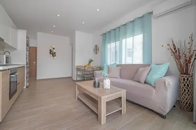 a living room with a couch and a table at Andreas Rodos Apartment in Rhodes Town