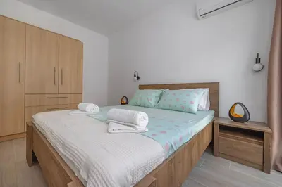 a bedroom with a bed with towels on it at Andreas Rodos Apartment in Rhodes Town