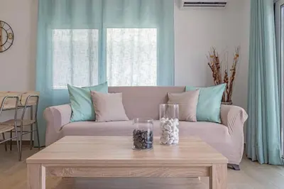 a living room with a couch and a coffee table at Andreas Rodos Apartment in Rhodes Town