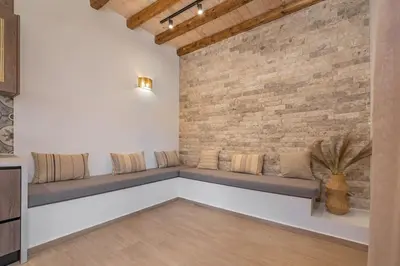 a room with couches against a brick wall at Casa di Marillia in Archangelos