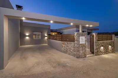 a large house with a fence and a driveway at Casa di Marillia in Archangelos