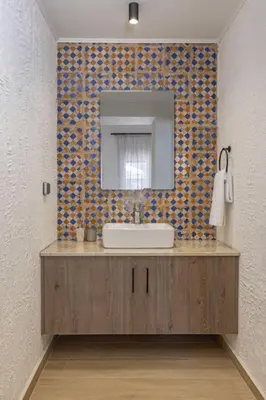 a bathroom with a sink and a mirror at Casa di Marillia in Archangelos