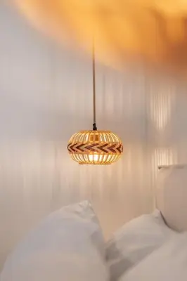 a pendant light hanging over a bed in a bedroom at Casa di Marillia in Archangelos