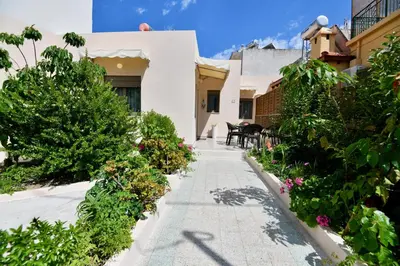 a courtyard of a house with flowers and plants at Elli's Private House in Ialyssos
