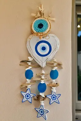 a wall with stars and a heart and a necklace at Elli's Private House in Ialyssos