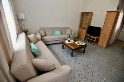 a living room with a couch and a coffee table at Elli's Private House in Ialyssos