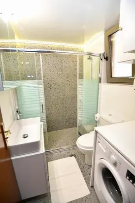 a bathroom with a shower and a toilet and a sink at Elli's Private House in Ialyssos