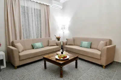 a living room with two couches and a coffee table at Elli's Private House in Ialyssos