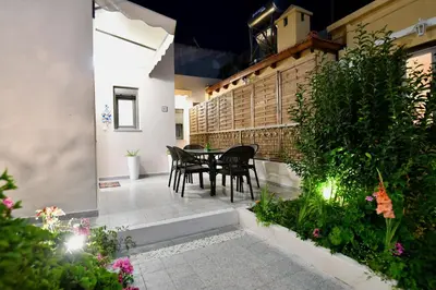 a patio with a table and chairs and plants at Elli's Private House in Ialyssos