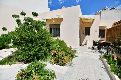 a house with a courtyard with flowers and plants at Elli's Private House in Ialyssos