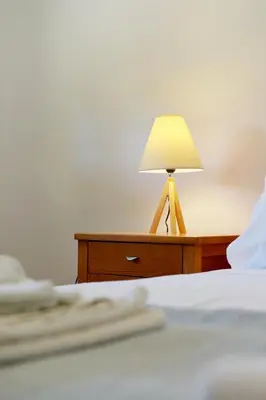 a lamp on a table next to a bed at Seaside Villa in Gennadi