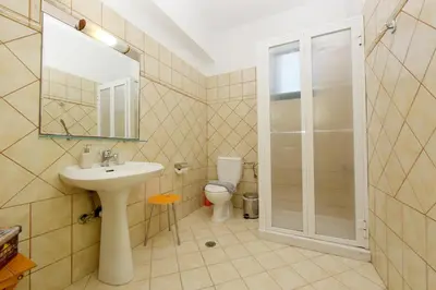 a bathroom with a sink and a toilet at Seaside Villa in Gennadi
