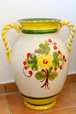 a yellow and white vase with flowers on it at Seaside Villa in Gennadi