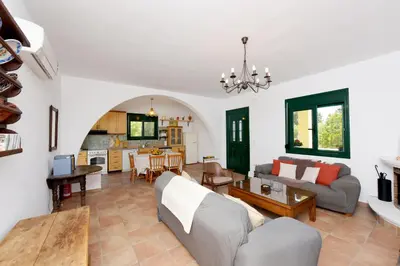 a living room with a couch and a table at Seaside Villa in Gennadi