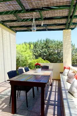 a patio with a table and chairs on a deck at Seaside Villa in Gennadi