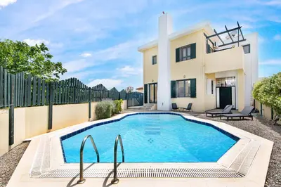 a swimming pool in front of a house at Anastasia Veranna Villa in Lachania