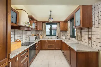 a large kitchen with wooden cabinets and a window at Anastasia Veranna Villa in Lachania