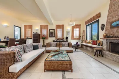 a living room with couches and a fireplace at Anastasia Veranna Villa in Lachania