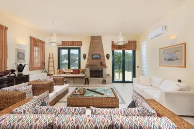 a living room with couches and a fireplace at Anastasia Veranna Villa in Lachania