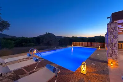 a swimming pool in a backyard at night at Olive Private Villa Swimming Pool 5 BDR Kolymbia Rhodes in Kolimbia