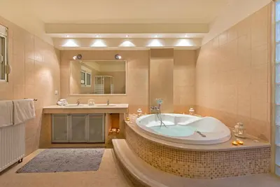 a large bathroom with a tub and a sink at Olive Private Villa Swimming Pool 5 BDR Kolymbia Rhodes in Kolimbia