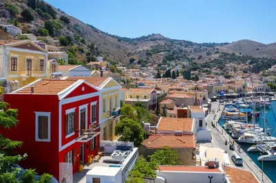 a view of a town with boats in a harbor at Annikas Port View-1st Floor in Symi