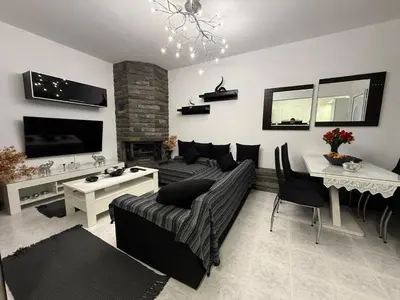 a living room with a couch and a table at Katsaras House 3 Cozy Bedrooms in Kremasti