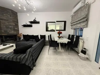 a living room with a couch and a table at Katsaras House 3 Cozy Bedrooms in Kremasti