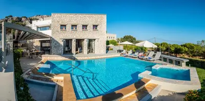 a large swimming pool in front of a house at Villa CostaMare - enjoy lazy days on the private Pool-Jacuzzi in Pefki Rhodes