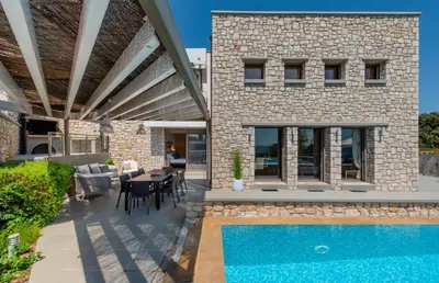 a patio with a swimming pool and a house at Villa CostaMare - enjoy lazy days on the private Pool-Jacuzzi in Pefki Rhodes