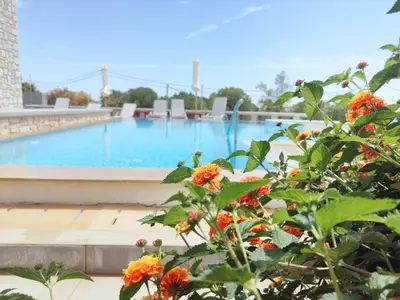 a view of a swimming pool with flowers in the foreground at Villa CostaMare - enjoy lazy days on the private Pool-Jacuzzi in Pefki Rhodes