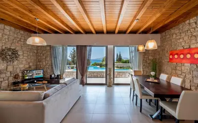 a living room with a couch and a table at Villa CostaMare - enjoy lazy days on the private Pool-Jacuzzi in Pefki Rhodes