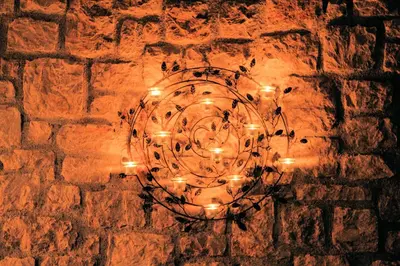 a chandelier with lights on a brick wall at Villa CostaMare - enjoy lazy days on the private Pool-Jacuzzi in Pefki Rhodes