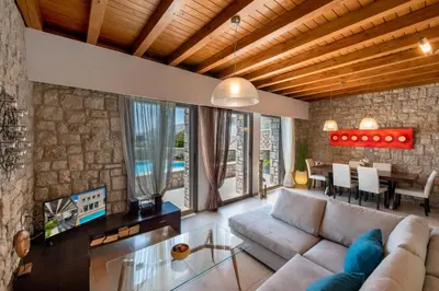 a living room with a couch and a table at Villa CostaMare - enjoy lazy days on the private Pool-Jacuzzi in Pefki Rhodes