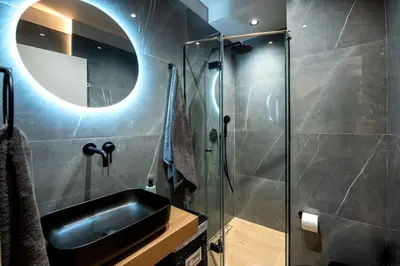 a bathroom with a sink and a shower at Santa Marina Luxury Apartments #2 with pool in Asgourou