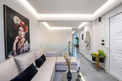 a living room with a couch and a painting on the wall at Santa Marina Luxury Apartments #2 with pool in Asgourou