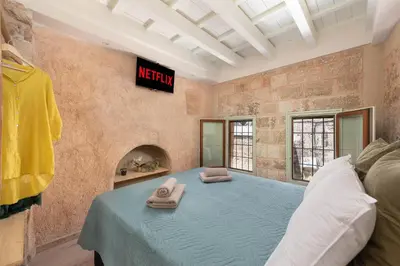 a bedroom with a bed with two towels on it at 4 Bedroom luxury home - Villa SoZoe in Rhodes Town