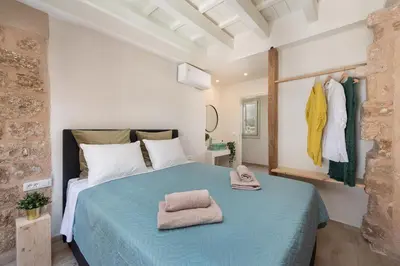 a bedroom with a bed with towels on it at 4 Bedroom luxury home - Villa SoZoe in Rhodes Town