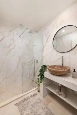 a bathroom with a sink and a glass shower at 4 Bedroom luxury home - Villa SoZoe in Rhodes Town