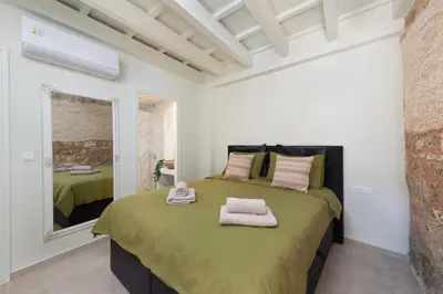 a bedroom with a large bed with towels on it at 4 Bedroom luxury home - Villa SoZoe in Rhodes Town