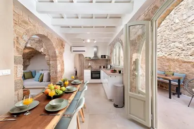 a kitchen and dining room with a table and chairs at 4 Bedroom luxury home - Villa SoZoe in Rhodes Town