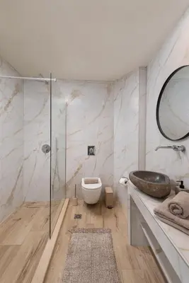 a bathroom with a sink and a toilet and a mirror at 4 Bedroom luxury home - Villa SoZoe in Rhodes Town