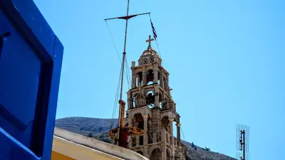 a tall tower with a clock on top of it at Duchess House in Symi