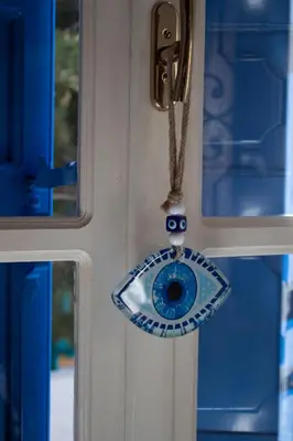 a blue door with a toyoglyctor hanging on it at Duchess House in Symi