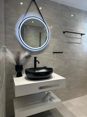 a bathroom with a black sink and a mirror at Nice n Cosy Apartment II in Rhodes Town